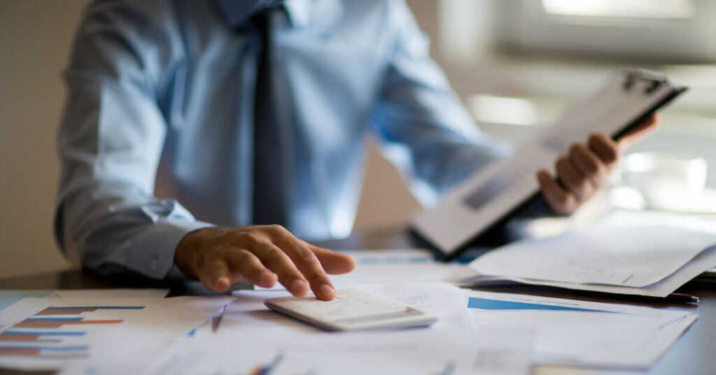 A man is calculating the ROI